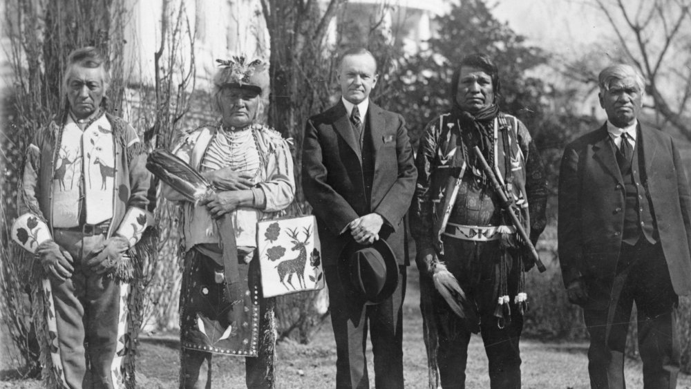 U.S. President Calvin Coolidge with four Osage Indians after Coolidge signed the bill granting Indians full citizenship, 1924
