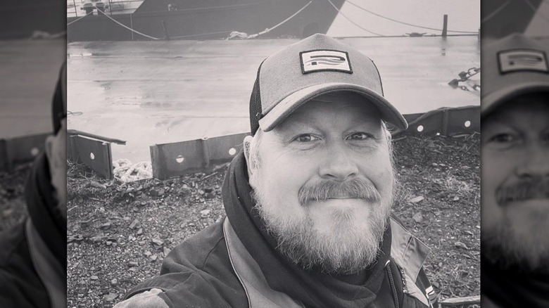 Casey McManus beard baseball cap smiling dock boat