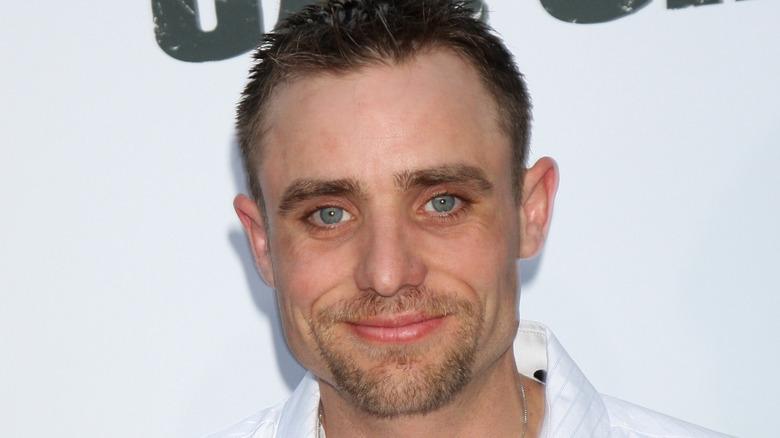 Jake Anderson smiling goatee white background