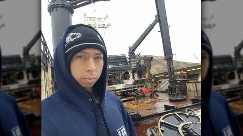 Todd Kochutin blue hoodie standing on fishing boat