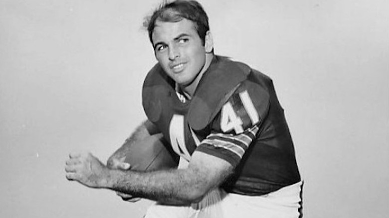 Brian Piccolo posing with football