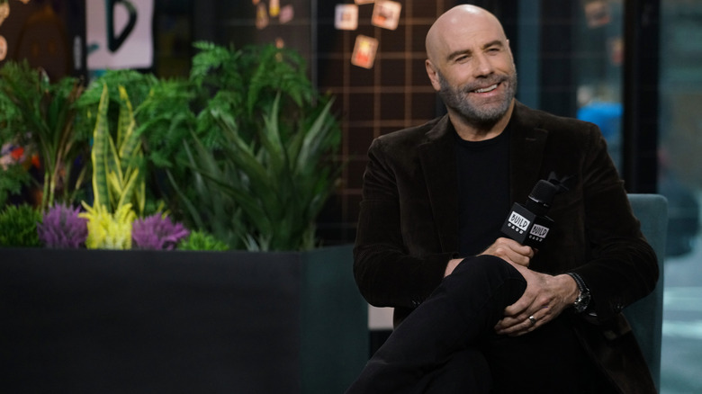 John Travolta giving interview plant background