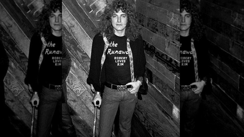 Robert Plant standing with a cane
