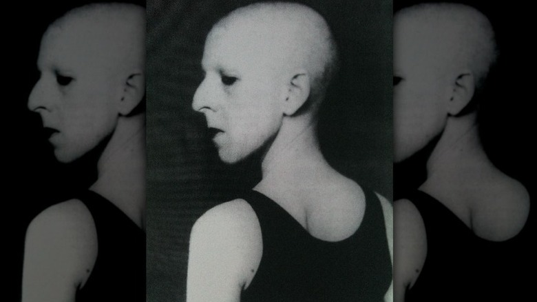 Self-portrait of Claude Cahun from rear black background