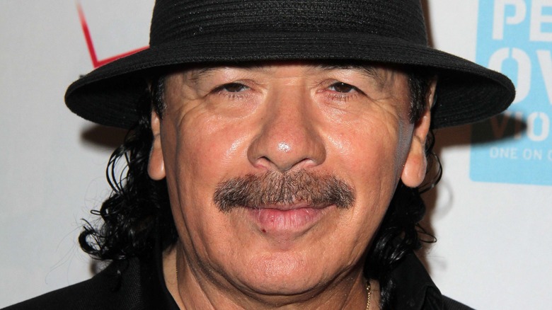 Carlos Santana in a black hat