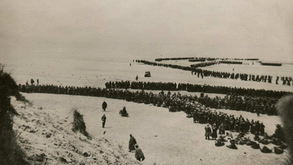 Military evacuation of Dunkirk during World War II. Thousands of British and French troops wait on the dunes of Dunkirk beach for transport to England. May 26-June 4, 1940.