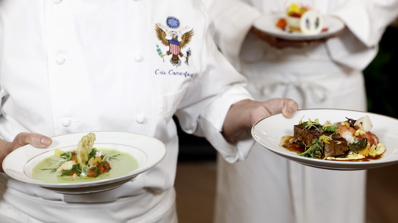 White House chefs hold plates of food