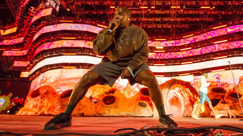 Kanye West singing into mic