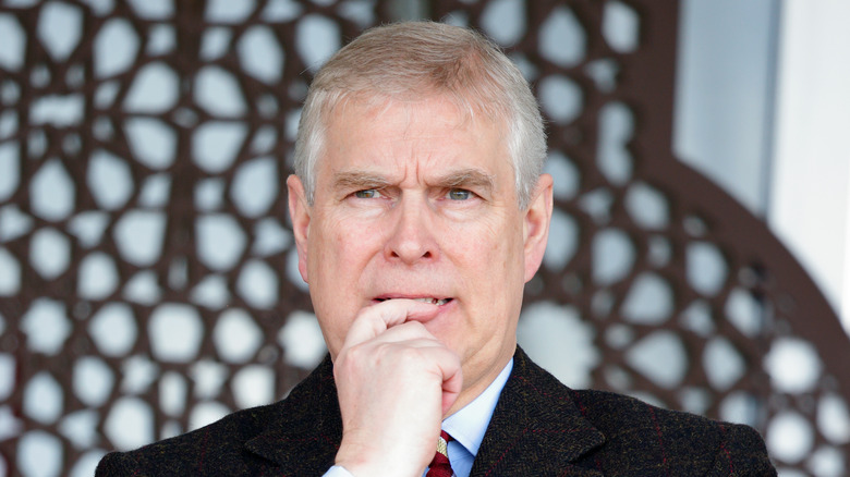 Prince Andrew looking pensive with finger to lips