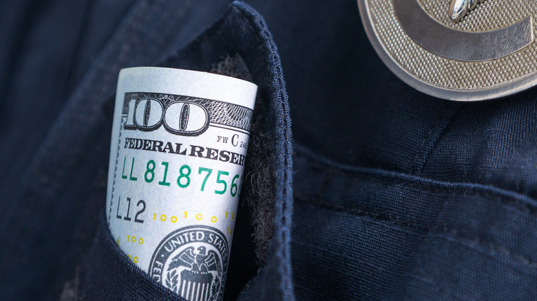 hundred-dollar bills in police pocket