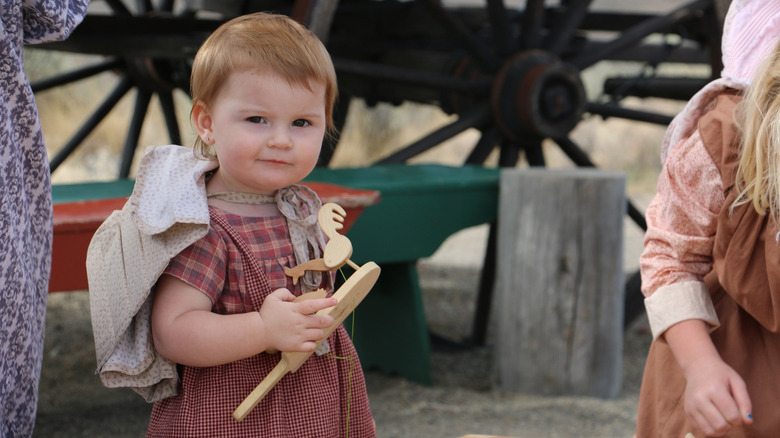 Pioneer reenactment child with toy