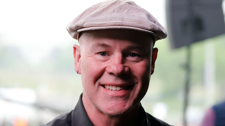 Thomas Dolby smiling flat cap 