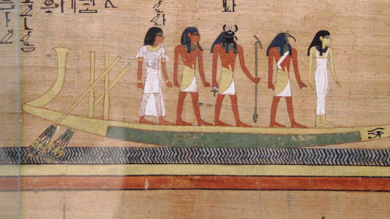 Souls on spiritual boat with ancient Egyptian gods