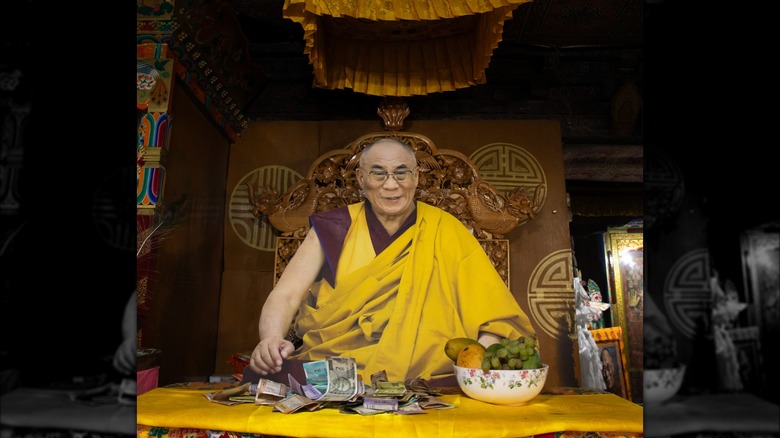 Dalai Lama smiling at table