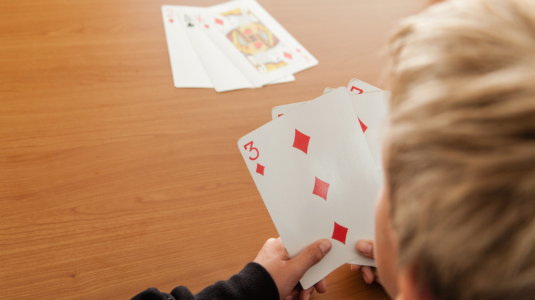 boy playing cards