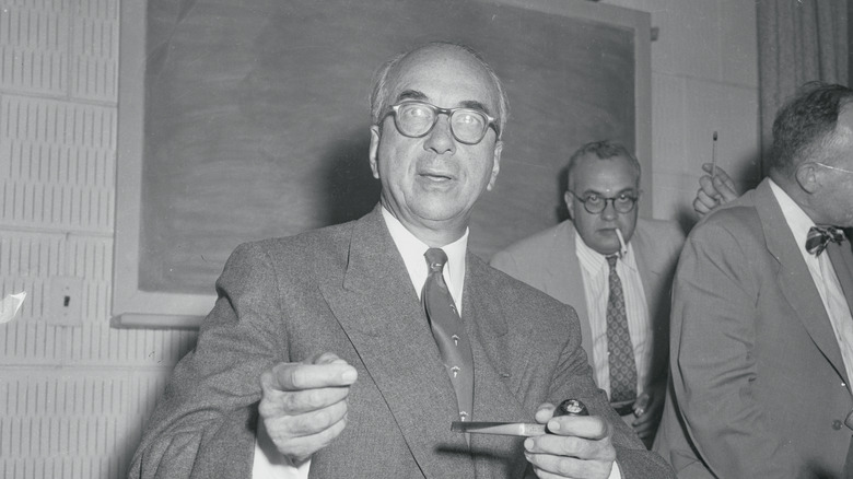 Lewis Strauss holds a pipe