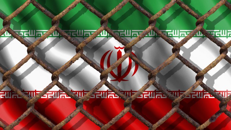 Iranian flag behind a fence