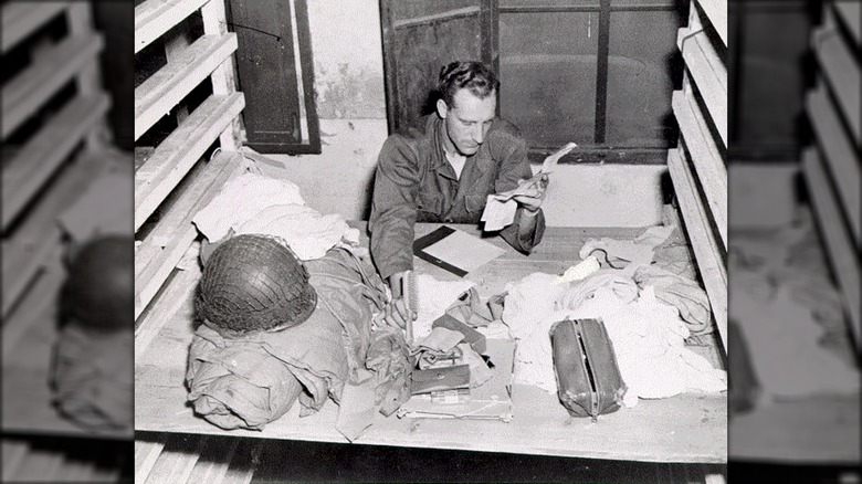 Soldier checking personal effects, World War II European theater