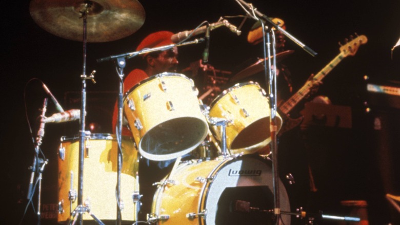 Carlton Barrett sitting behind the drum kit onstage