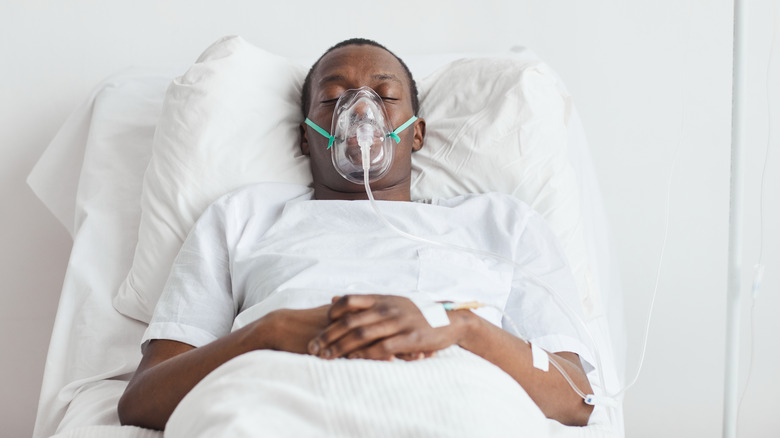 Man wearing oxygen mask in bed