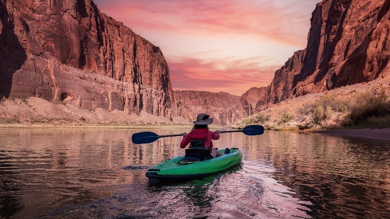 woman kayaking through Colorado River canyon