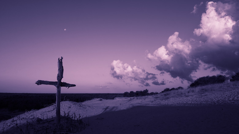 Cross on hill purple background