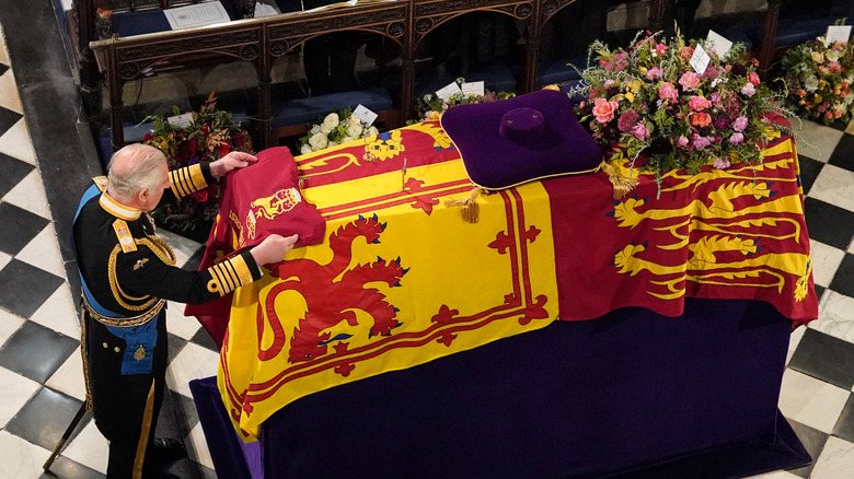 King Charles III lays colour on Queen Elizabeth's casket 