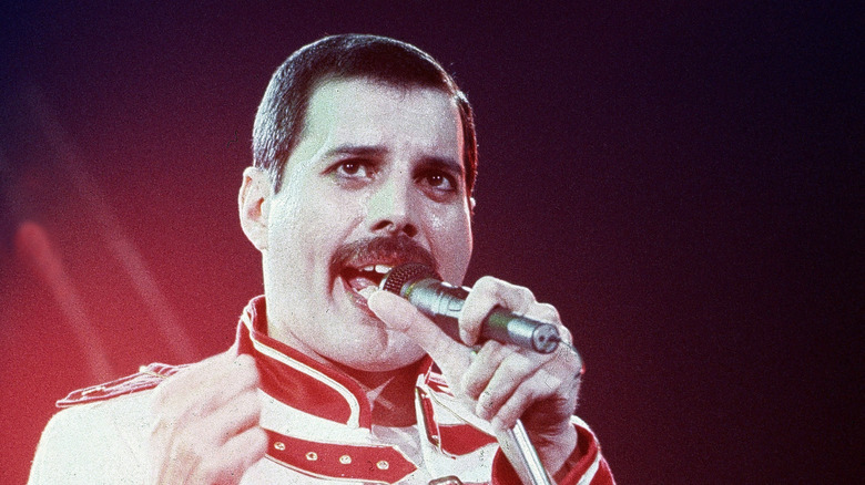 Freddie Mercury in military outfit with microphone