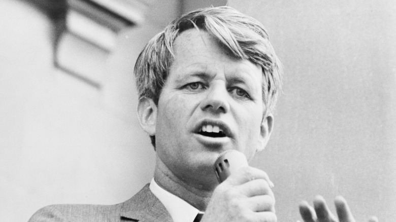 Robert F. Kennedy holding microphone