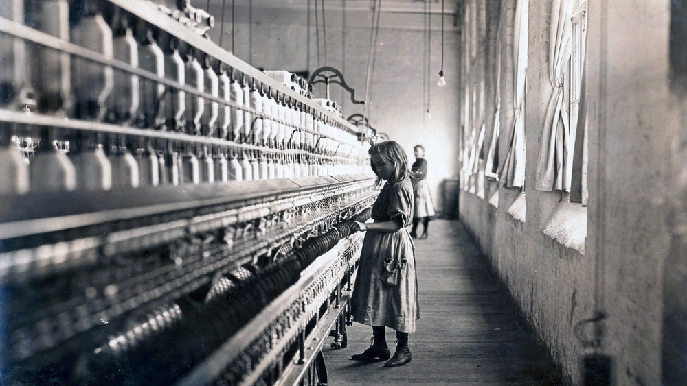 Child laborer at work in a cotton mill 