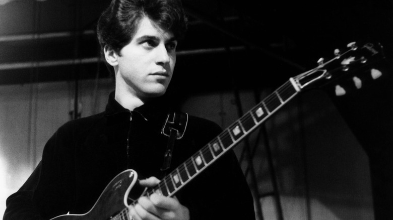 Johnny Rivers holding a guitar