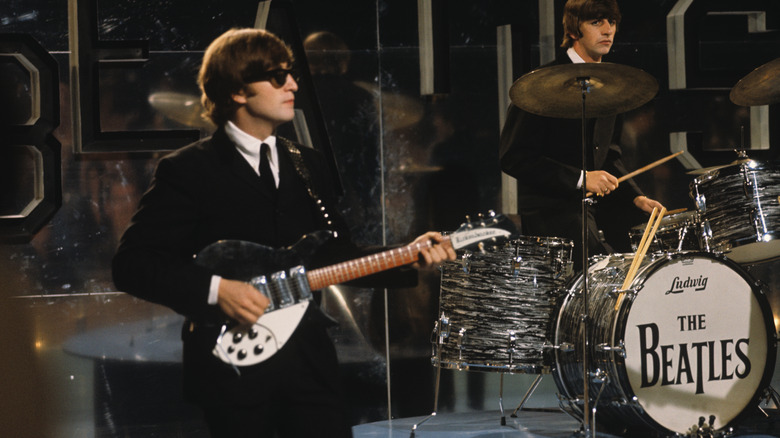 John Lennon and Ringo Starr performing on stage