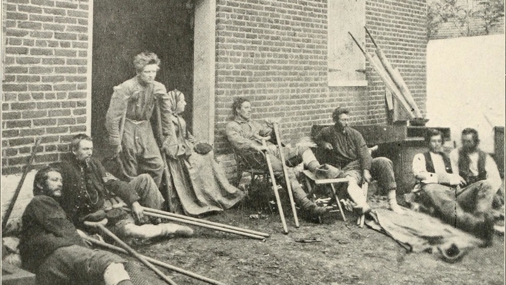A nurse and wounded Union soldiers outside