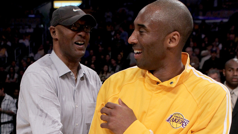 Kobe with his father, Joe Bryant, smiling 