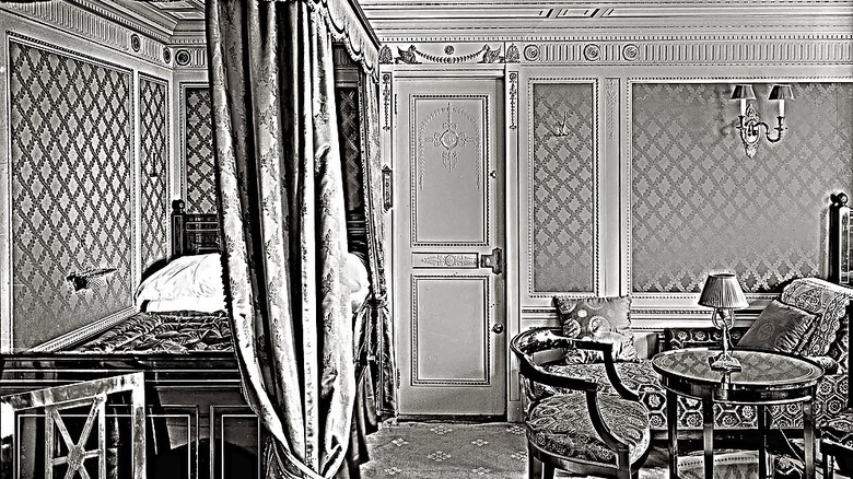 Black and white image of suite with ornate bedding