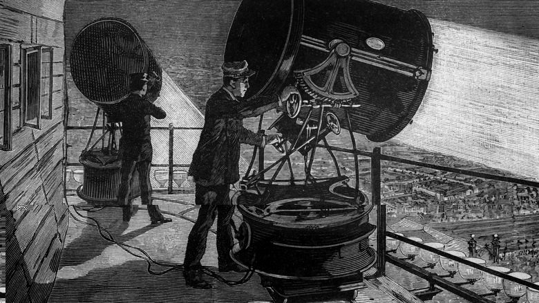 Installation of electric light projectors built by Sautter and Lemonnier on the terrace of the Eiffel Tower engraving from the book "Album of science famous scientist discoveries" in 189