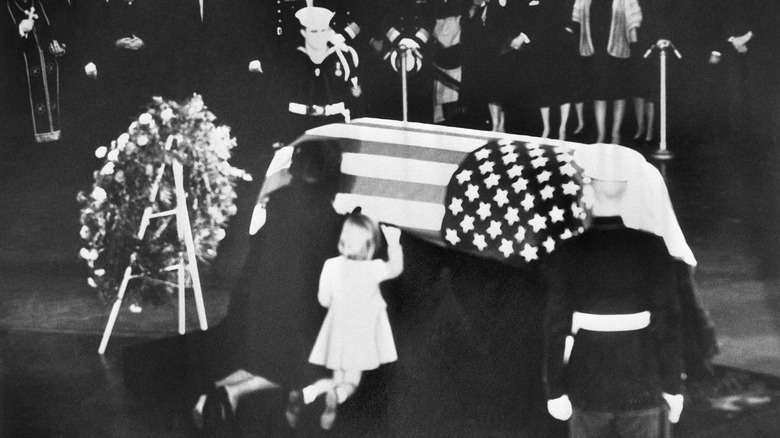 Jackie and Caroline Kennedy kneeling by JFK's casket