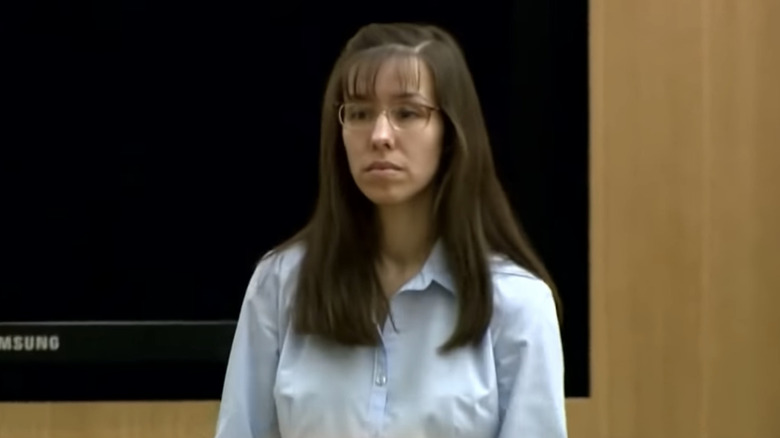 Jodi Arias stands in court straight-faced shirt