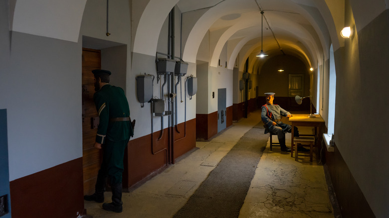 guard sitting in prison hallway