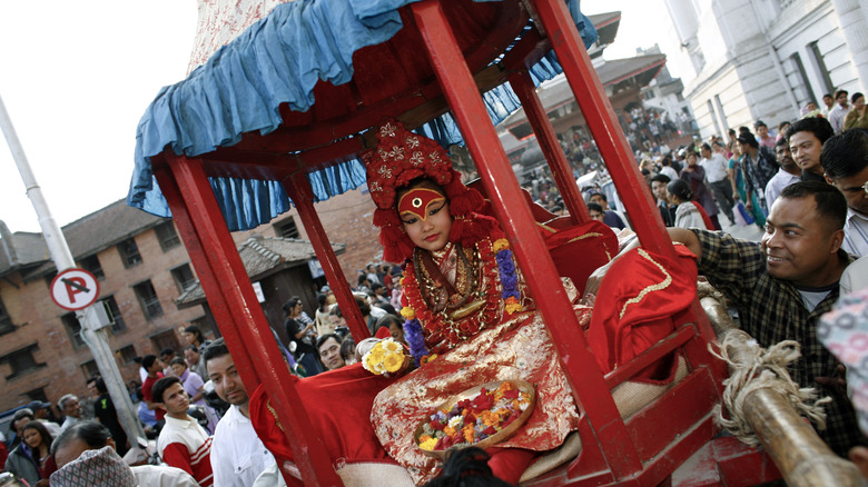 Kumari Devi, or Royal Living Goddess, Preeti Shakya, 9, rides in the royal chariot on her way the White Machindranath Chariot festival March 28, 2007 in Kathmandu, Nepal