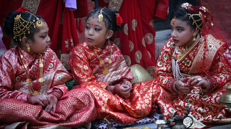 Small girls from Newar community attend a Bel Bibaha ceremony, a marriage ceremony for pre-adolescent girls marrying to bael fruit (wood apple)