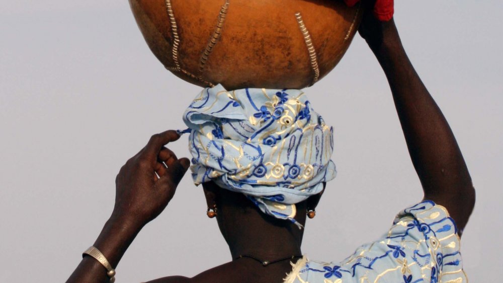 A Peul woman from Mali balancing a calabas on her head
