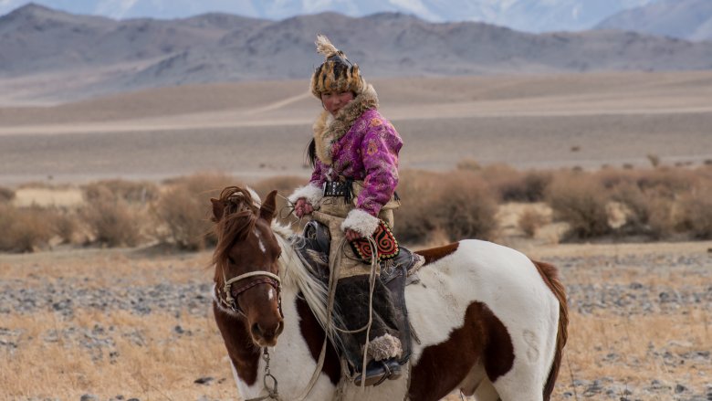 Mongolian woman on horseback