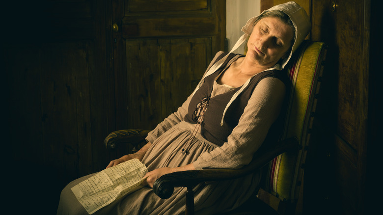 medieval woman sleeping in a chair