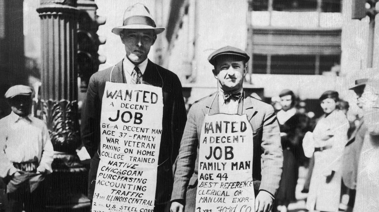 Men with signs looking for jobs