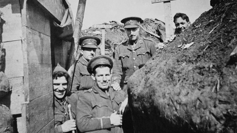 Soldiers in trench smiling