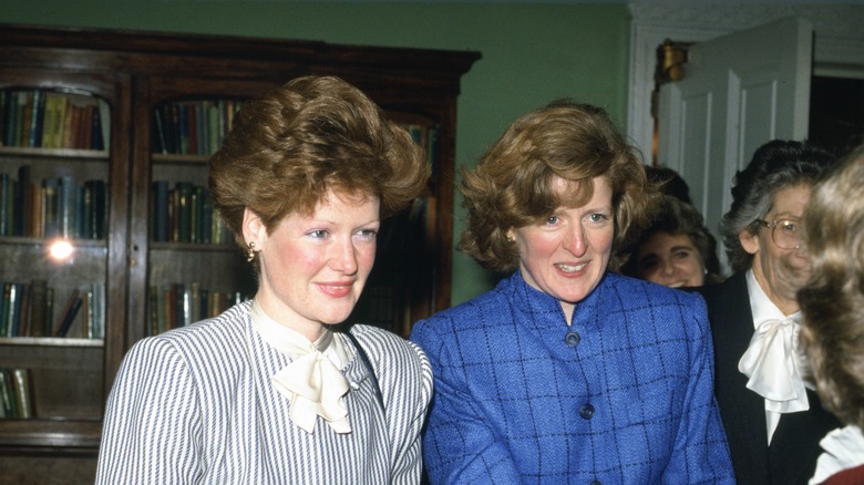 Princess Diana's sisters speaking to a woman inside