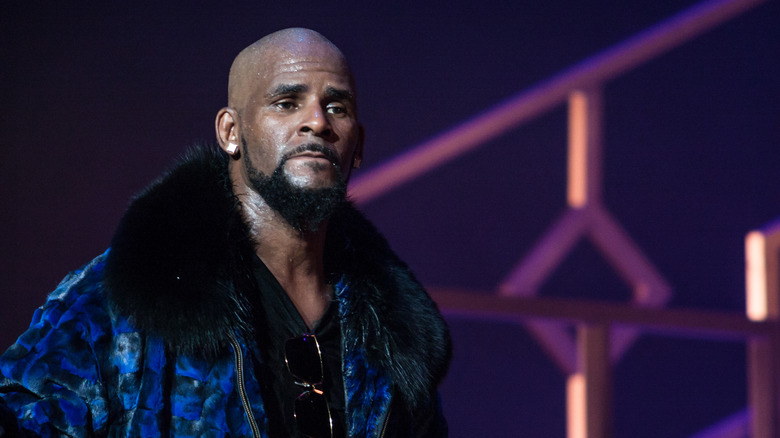 R. Kelly onstage in blue collared jacket