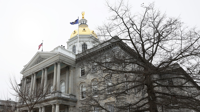 Wind blows flags New Hampshire capitol