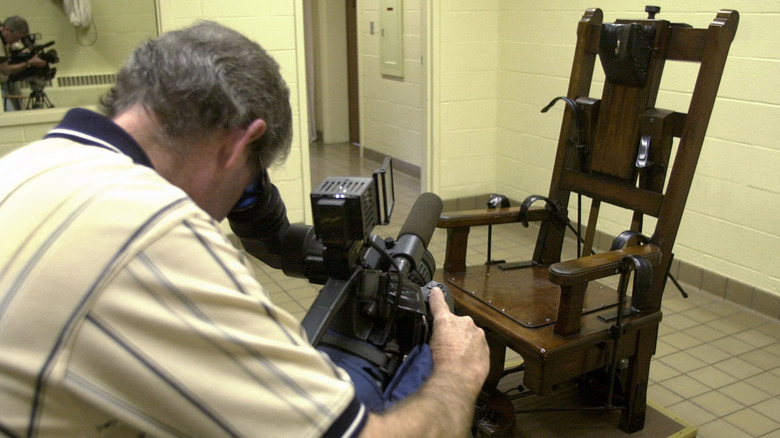 photographer taking close-up video of the electric chair